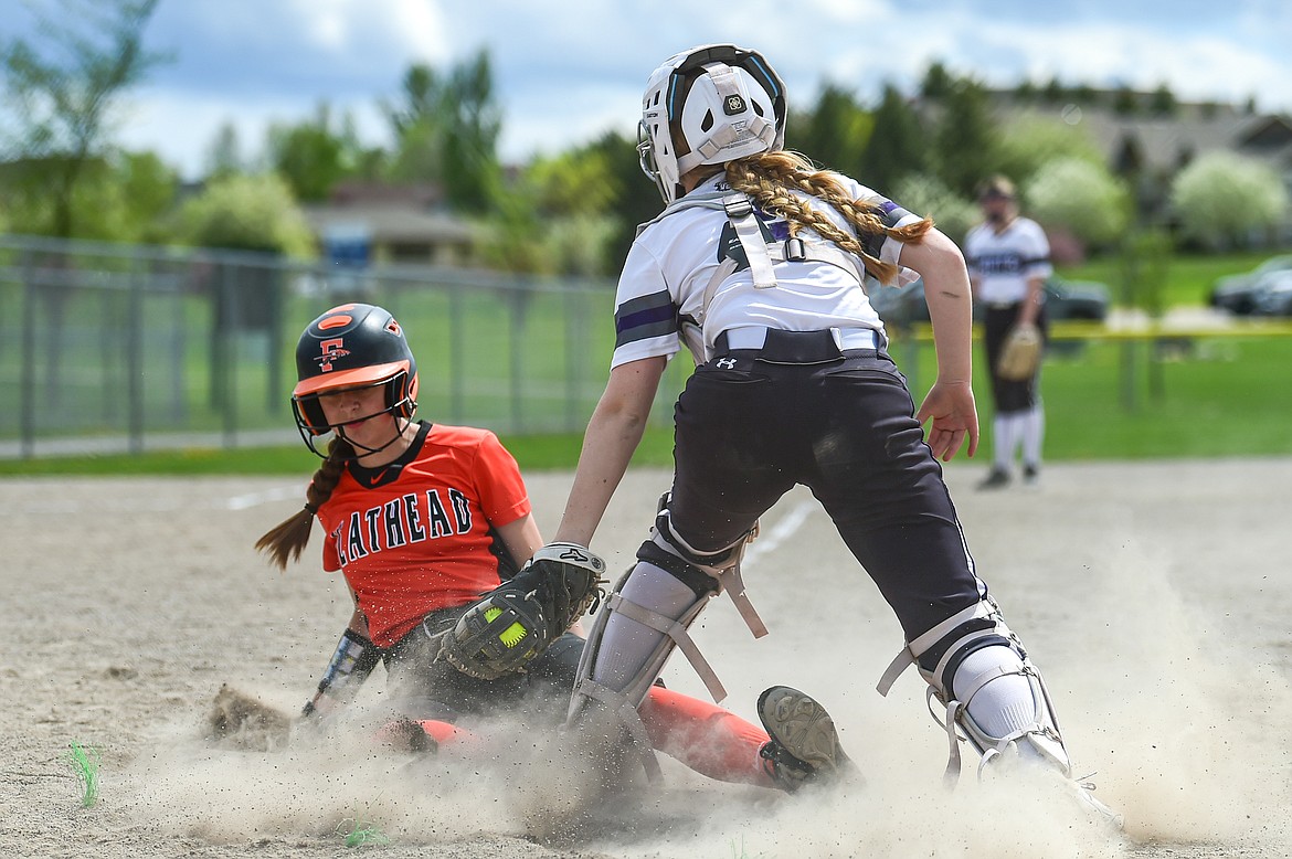 Flathead's Kinsey Lake (9) slides into home ahead of the tag to score the tying run in the bottom of the seventh inning against Butte at Kidsports Complex on Tuesday, May 14. (Casey Kreider/Daily Inter Lake)