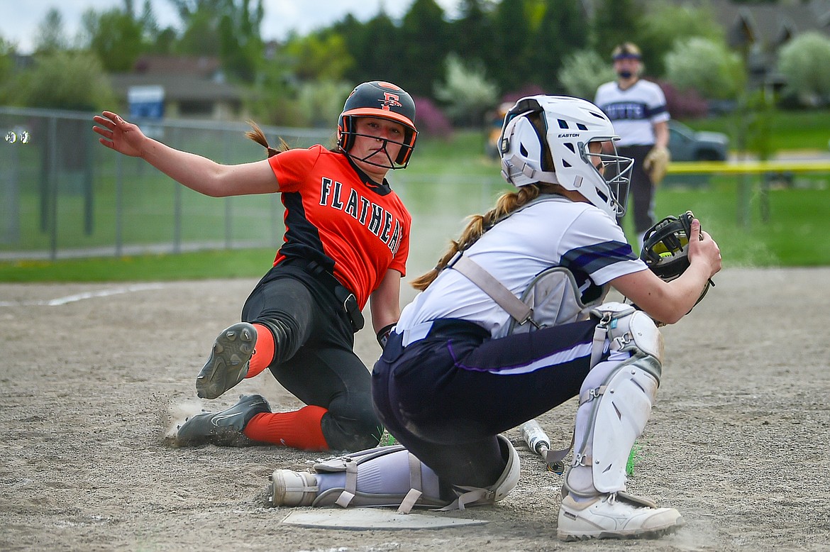 Flathead's Ava Bessen (4) slides into home ahead of the tag in the first inning against Butte at Kidsports Complex on Tuesday, May 14. (Casey Kreider/Daily Inter Lake)