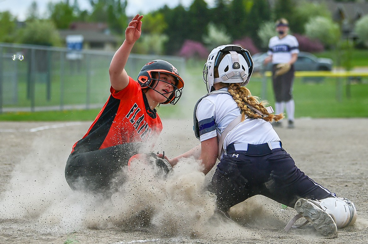 Flathead's Ava Bessen (4) slides into home ahead of the tag in the first inning against Butte at Kidsports Complex on Tuesday, May 14. (Casey Kreider/Daily Inter Lake)