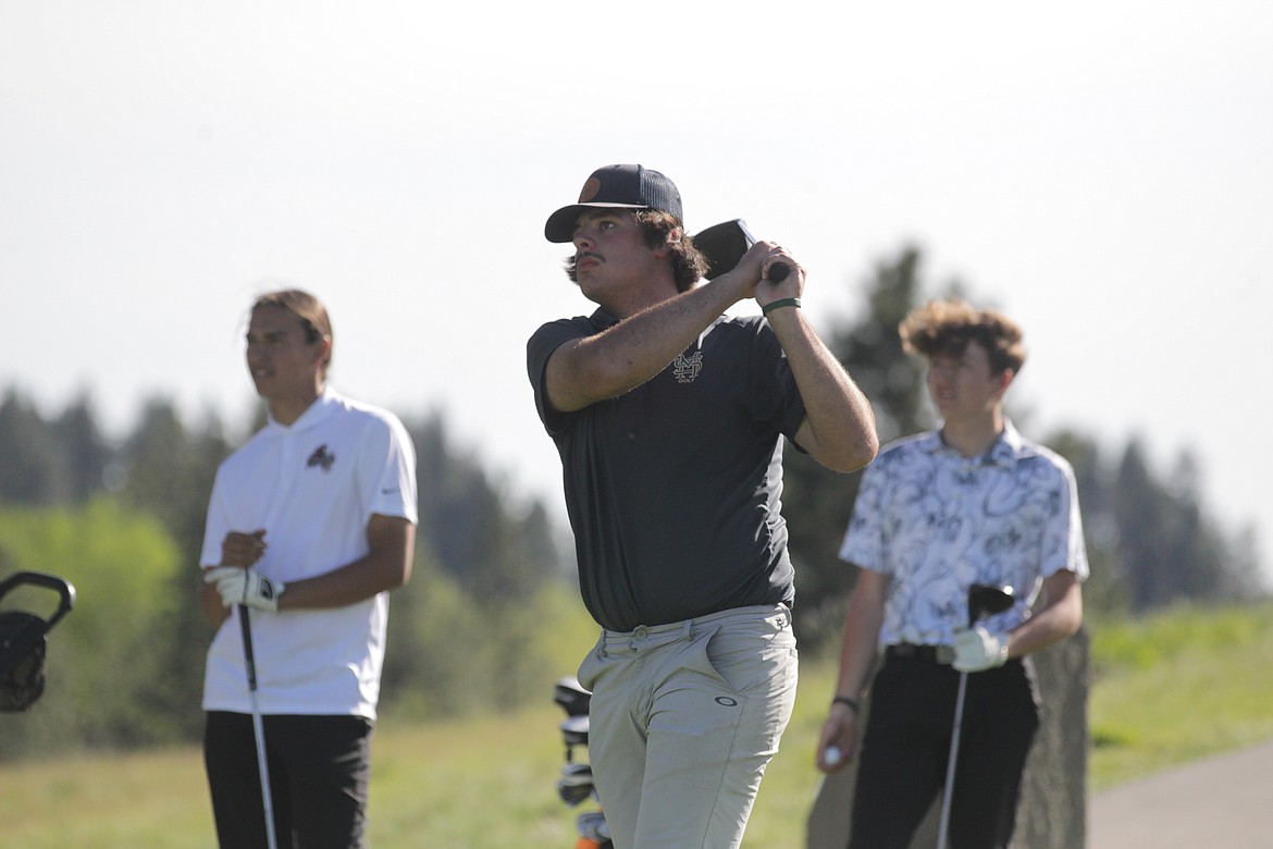 MARK NELKE/Press
Seth Swallows of St. Maries watches his tee shot on the 11th hole at Circling Raven Golf Club in Worley, in the final round of the state 2A golf tournament. Watching is Beau Jones, left, of Lakeside, and Palmer Coleman of Priest River.