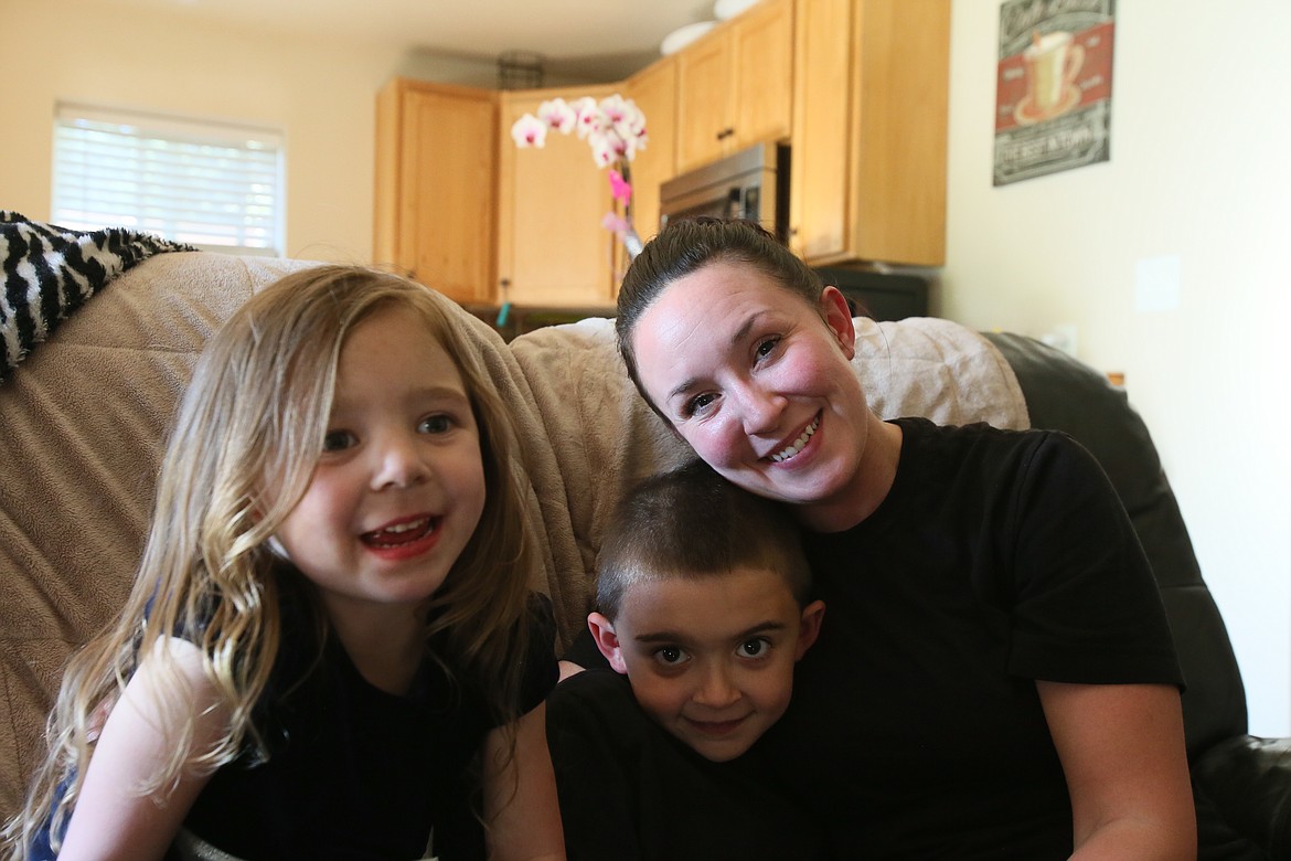 Ellie, 5, Austin, 7, and Heather Bischof share a family moment in their new rental home May 9. "There's a lot of times I’m standing here physically looking around in shock that I’m still actually here," Bischof said, "this is actually mine and I did this and got this far."