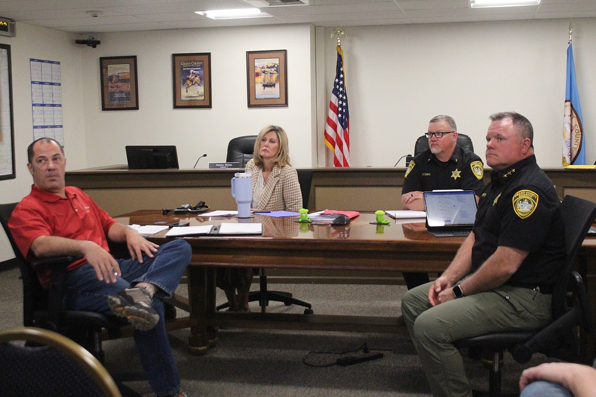From left, project manager Marc Seeberger, Grant County Commissioner Cindy Carter, Phil Coats, chief corrections deputy for the Grant County Sheriff’s Office and Grant County Sheriff Joe Kriete get a first look at the estimated cost of the Grant County Jail in early April. Commissioners approved an agreement for a “guaranteed maximum price” for jail construction Tuesday.
