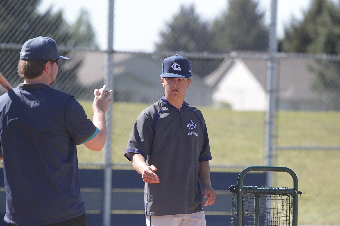 JASON ELLIOTT/Press
Lake City High senior Cooper Smith throws a ball to assistant coach Cody Garza during infield practice on Friday at Lake City High.