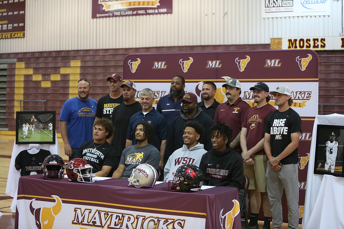 Four Moses Lake football players signed on to play college football on Monday; seniors Joel Middleton, front row right, and Hayden Throneberry, front row left, signed to play at Whitworth University. Senior Caleb Jones, front row center left, is heading to Pacific Northwest Christian College, and senior Kyson Thomas, front row center right, will play at Washington State University.