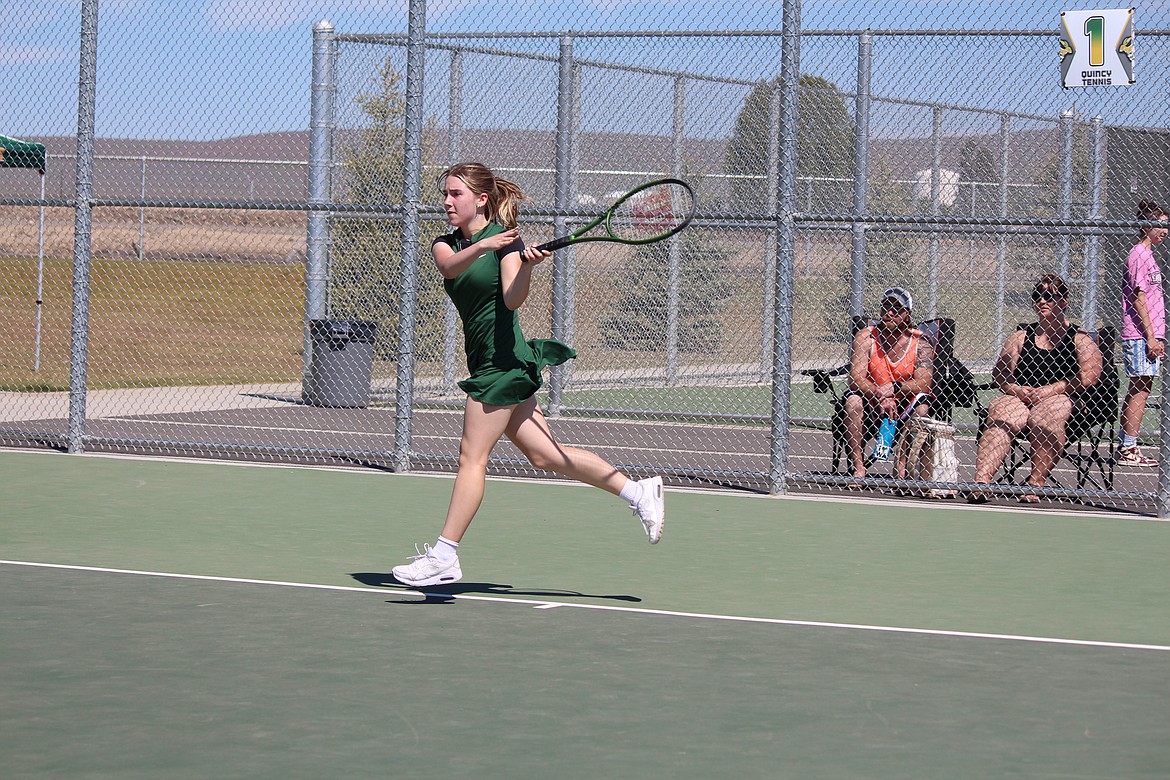 Caia Williams powers through a return in the girls District 6 tournament in Quincy Saturday.