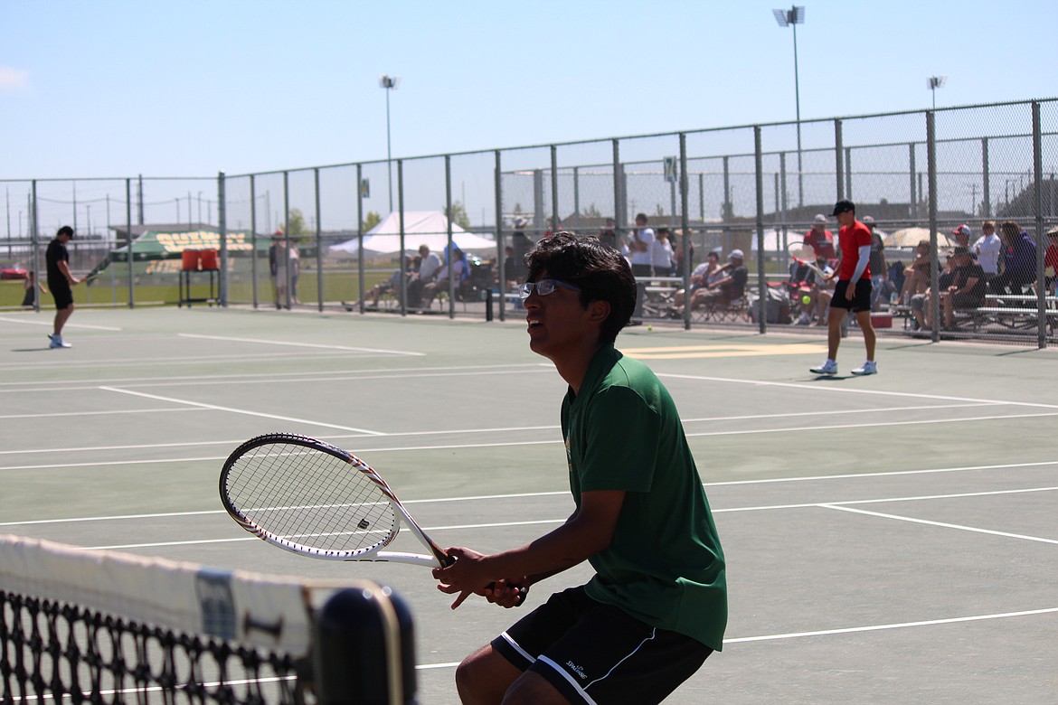 Victor Torres waits for the ball during doubles play Saturday in Quincy.