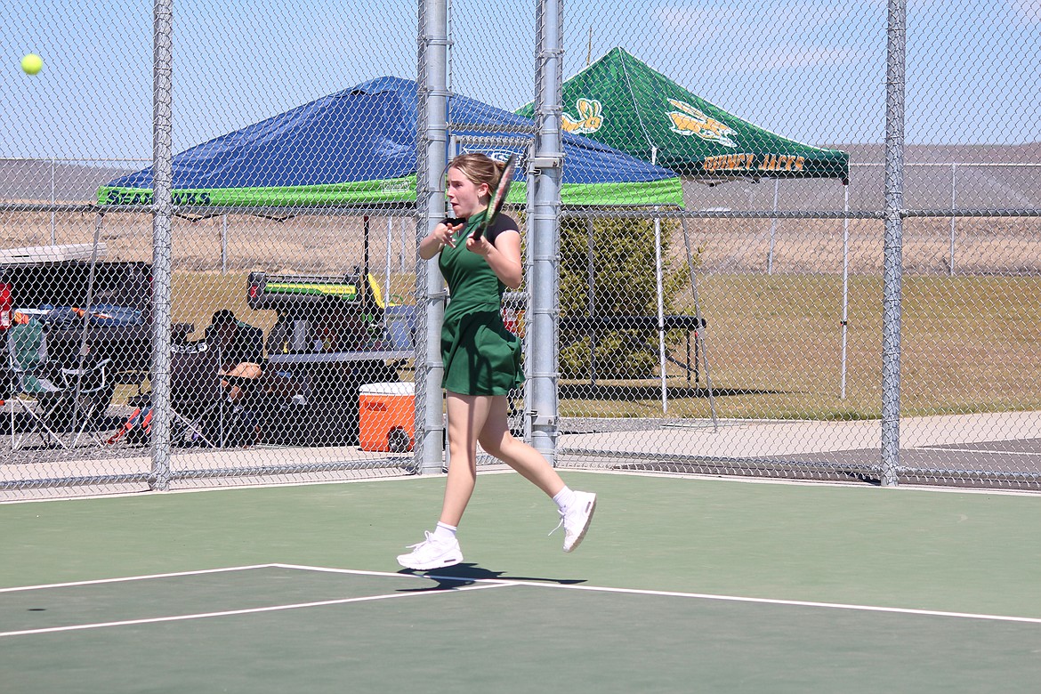 Quincy’s Caia Williams volleys the ball down the line in singles competition at the girls District 6 championships.