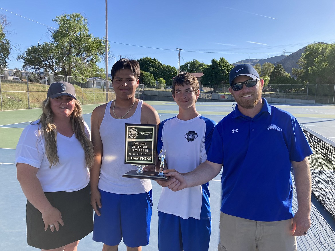 Soap Lake assistant coach Clarissa Larsen, left, sophomore Francisco Ortega, sophomore Xavier Gonzales-Robinson and Head Coach Lee Leavell pose with the trophy after winning the Central Washington B league tournament on Saturday.