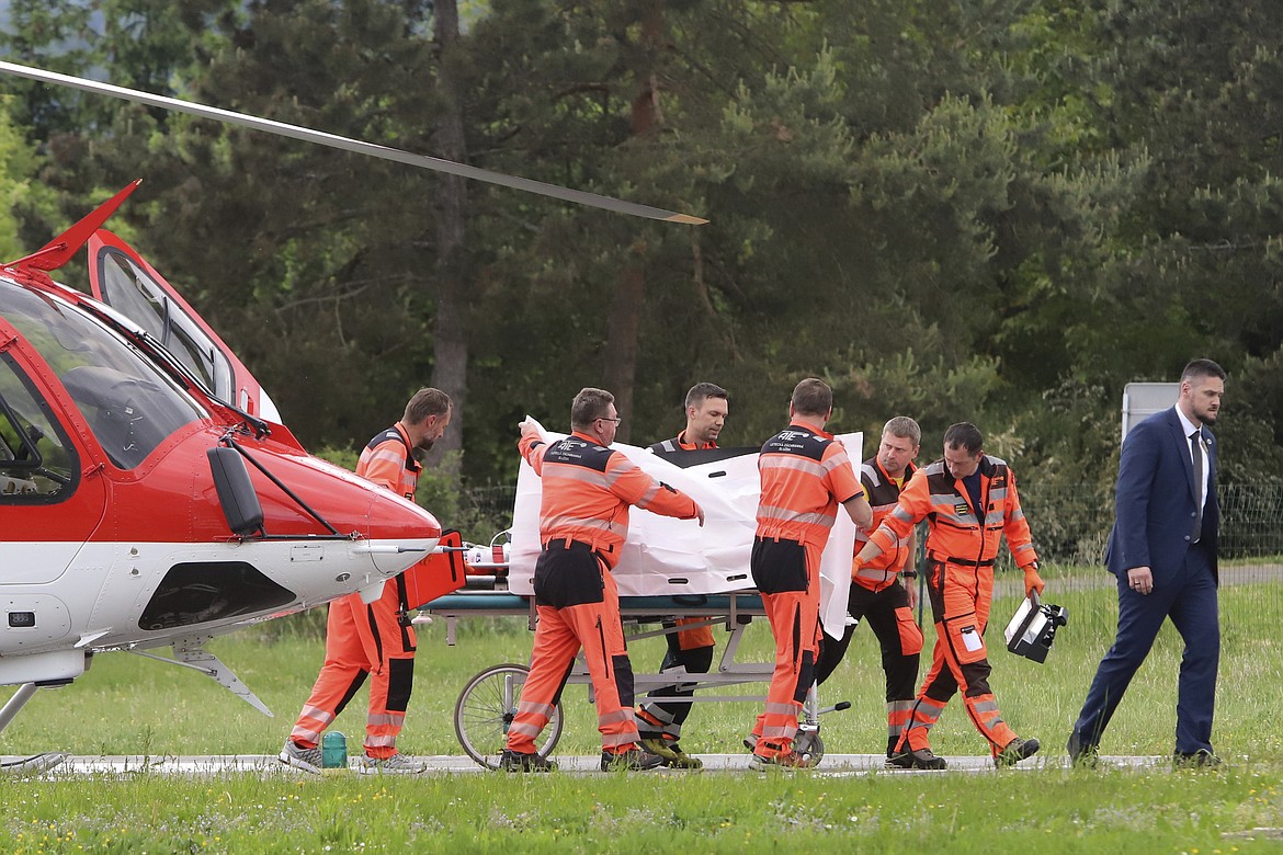 Rescue workers wheel Slovak Prime Minister Robert Fico, who was shot and injured, to a hospital in the town of Banska Bystrica, central Slovakia, Wednesday, May 15, 2024. Slovakia's populist Prime Minister Robert Fico is in life-threatening condition after being wounded in a shooting Wednesday afternoon, according to his Facebook profile. (Jan Kroslak/TASR via AP)