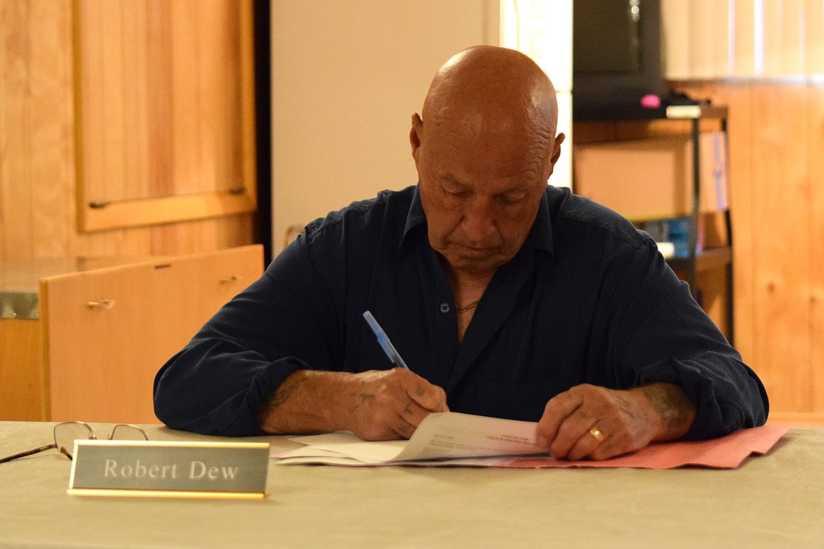 Lind Town Council member Robert Dew looks over documents during Tuesday evening’s regular council meeting, during which the council approved Dew’s motions to rescind the council’s April 23 vote to vacate Mayor Paula Bell’s position.