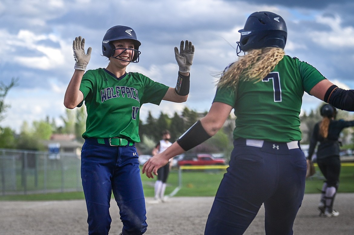 Glacier's Olivia Warriner (10) and Cazz Rankosky (7) celebrate after scoring on Warriner's two-run double after a pair of throwing errors in the seventh inning against Flathead at Kidsports Complex on Thursday, May 16. (Casey Kreider/Daily Inter Lake)