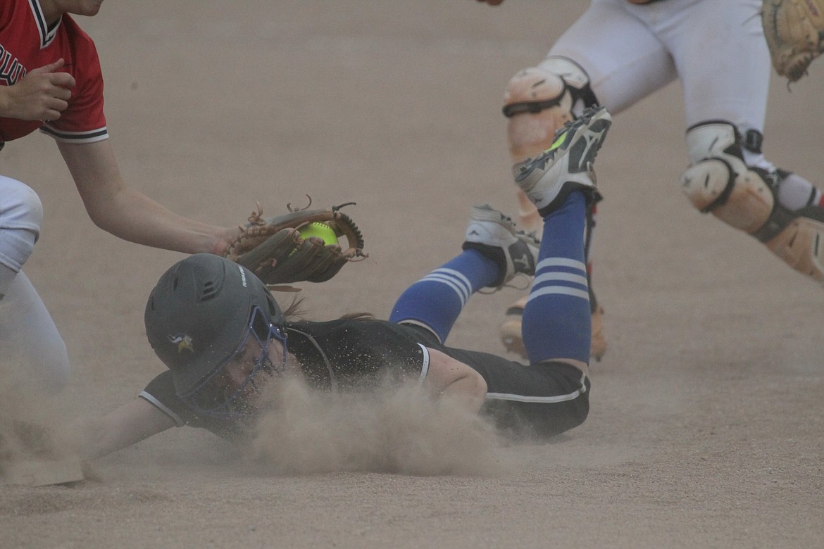 MARK NELKE/Press
Coeur d'Alene senior Abby Moehring dives safely back to third base following a rundown against Owyhee of Meridian in the first round of the state 5A softball tournament Thursday at Post Falls High.