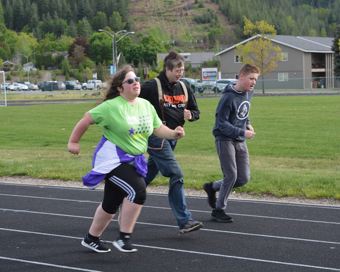 Kristin Payne, Justin Argiro and Connor North sprint during practice for the Silver Valley Special Olympics team Wednesday.