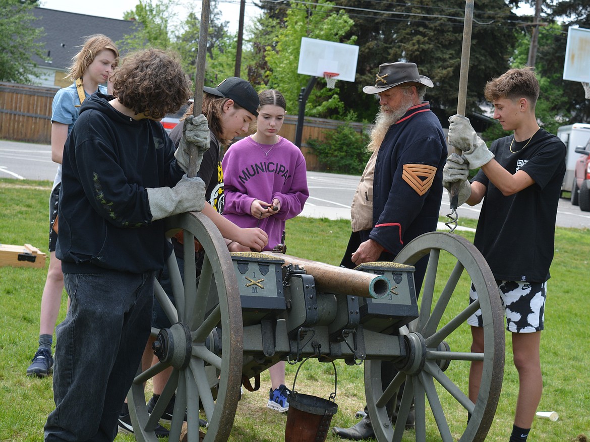 Civil War reenactor Gene Black walks students through cannon firing safety procedures and etiquette.From left: Soren Swingrover, Gage Marmon, Maximus Lilley, Lillian Dirks, Gene Black and Asynn Gentry.