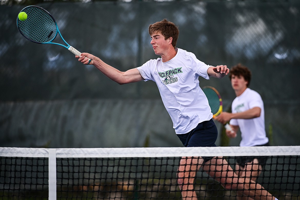 Glacier's Sam Engellant reaches for a return at the net in the boys doubles final with teammate Will Rudbach against Great Falls CMR's Eli Crist and Josh Stimac at the AA Northern Divisional Tennis Tournament at Flathead Valley Community College on Friday, May 17. (Casey Kreider/Daily Inter Lake)