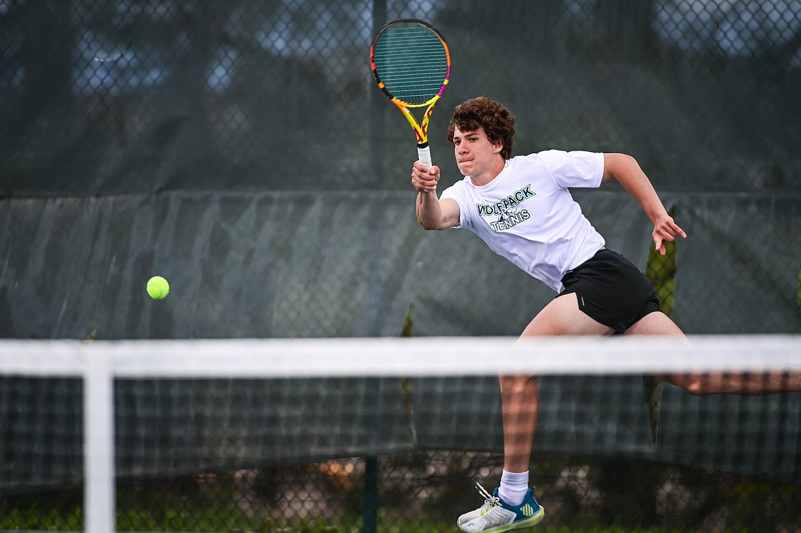 Glacier's Will Rudbach reaches for a return in the boys doubles final with teammate Sam Engellant against Great Falls CMR's Eli Crist and Josh Stimac at the AA Northern Divisional Tennis Tournament at Flathead Valley Community College on Friday, May 17. (Casey Kreider/Daily Inter Lake)