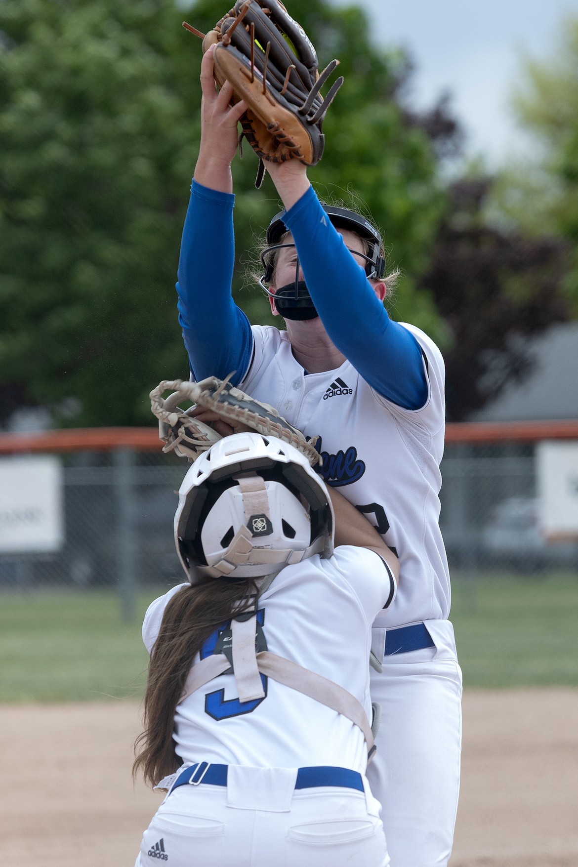 Courtesy photo
Coeur d'Alene pitcher Jenna Davenport catches a bunt pop-up as she collides with catcher Kyndal Bridge against Timberline in the second round of the 5A state softball tournament Friday at Post Falls High.