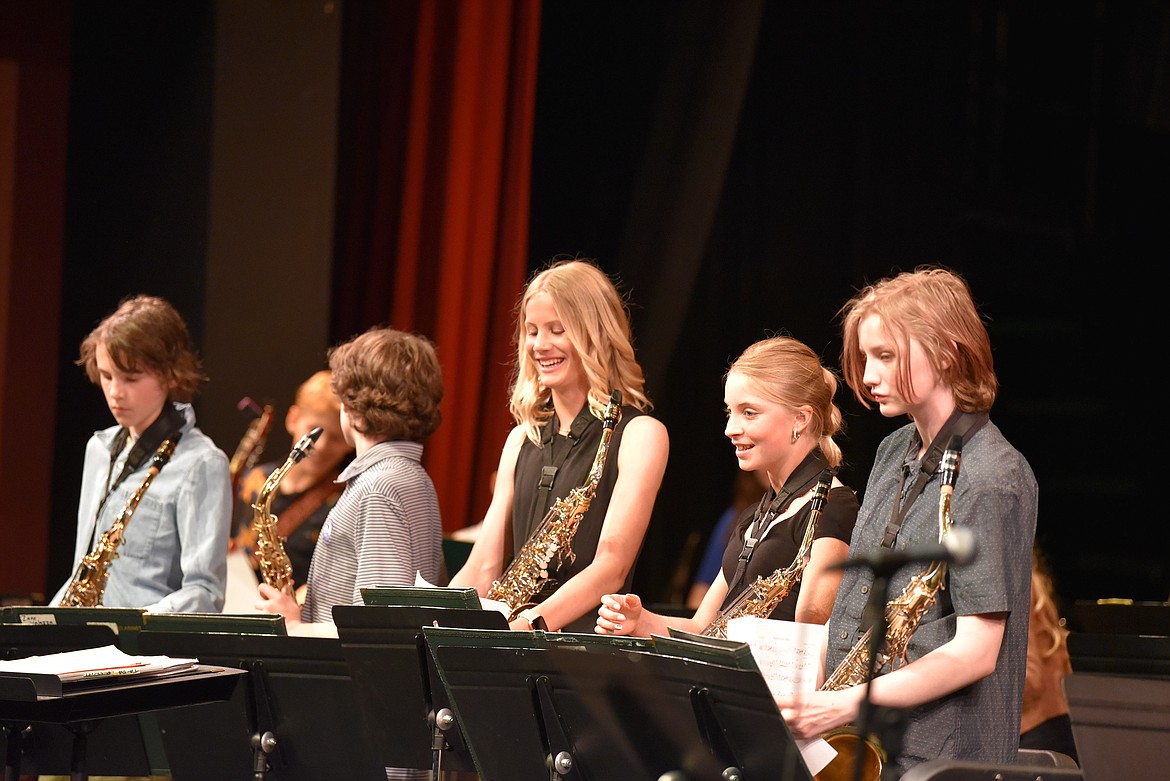 7th grader Ingrid Johnson is all smiles at the conclusion of a combined band ensemble at the Whitefish Middle School band concert. Also pictured are Zane Valazza, James Weyh (back to camera), Lilah Kulzer and Oliver Browning. (Kelsey Evans/Whitefish Pilot)