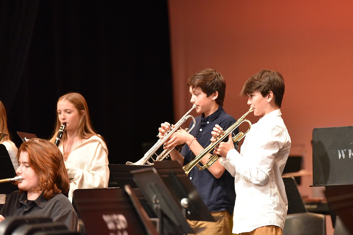 Alex Daniels (seated), Jaylynn Johnson (clarinet), Noah Drace (trumpet) and Noah Thomas (trumpet) at the Whitefish Middle School spring band concert (Kelsey Evans/Whitefish Pilot).