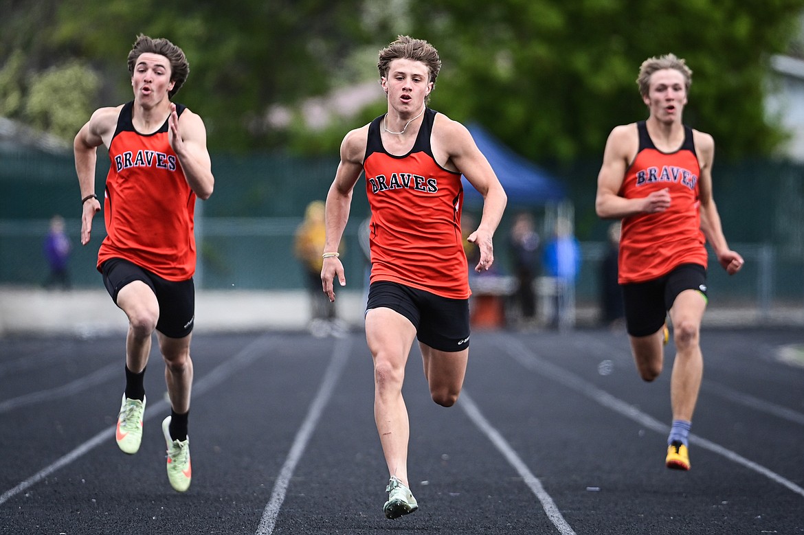 The Flathead trio of Ben Bliven, center, Brody Thornsberry, left, and Will Hollensteiner, right, placed first, second and fourth respectively in the boys 200 meter run at the Western AA Divisionals at Legends Stadium on Saturday, May 18. (Casey Kreider/Daily Inter Lake)