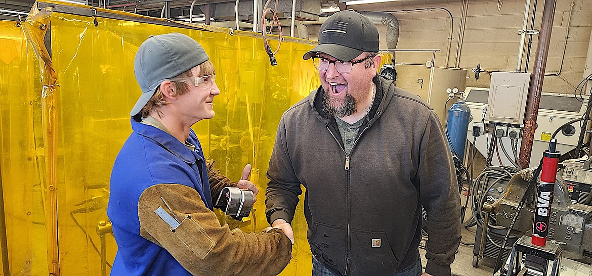 Libby student Connor Benson is congratulated by certified welding inspector Blake Thompson after passing his destructive test. (Photo courtesy John Love)
