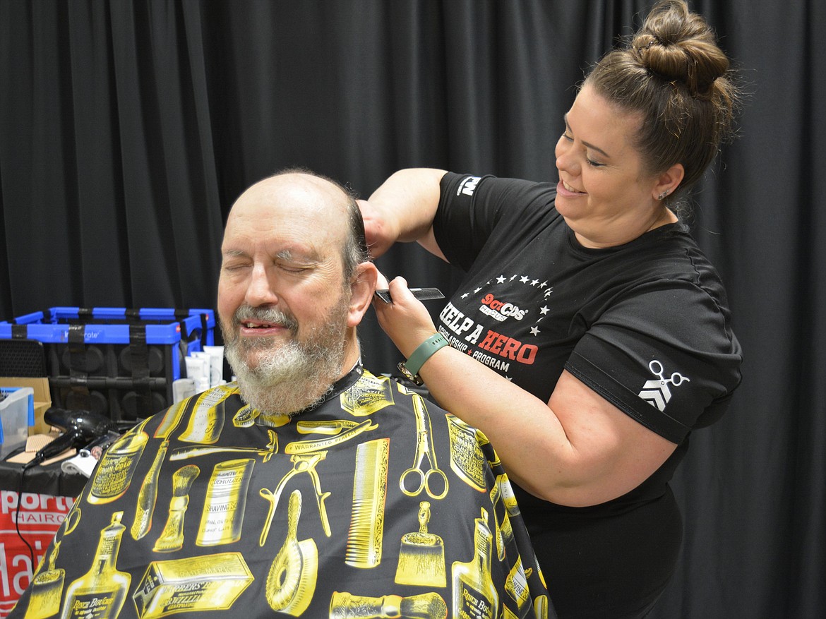 Greg Lindberg relaxes during a haircut by Amber Stewart during the Veterans Stand Down at the Kootenai County Fairgrounds.