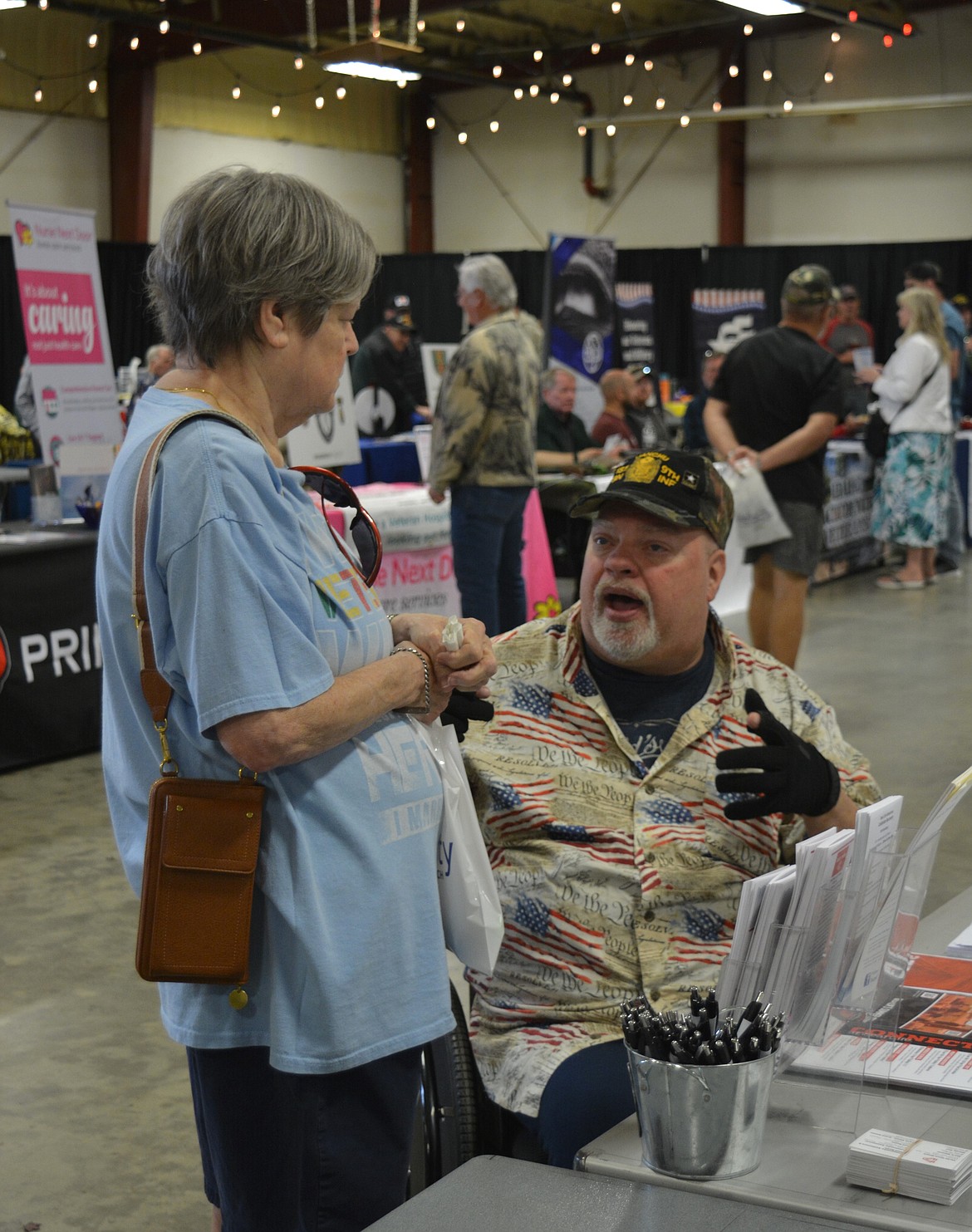 Terri Gasper and Douglas Harsh were two among hundreds in attendance during the Veterans Stand Down Saturday at the Kootenai County Fairgrounds. Harsh shared information about church services and other resources available through Real Life Ministries.