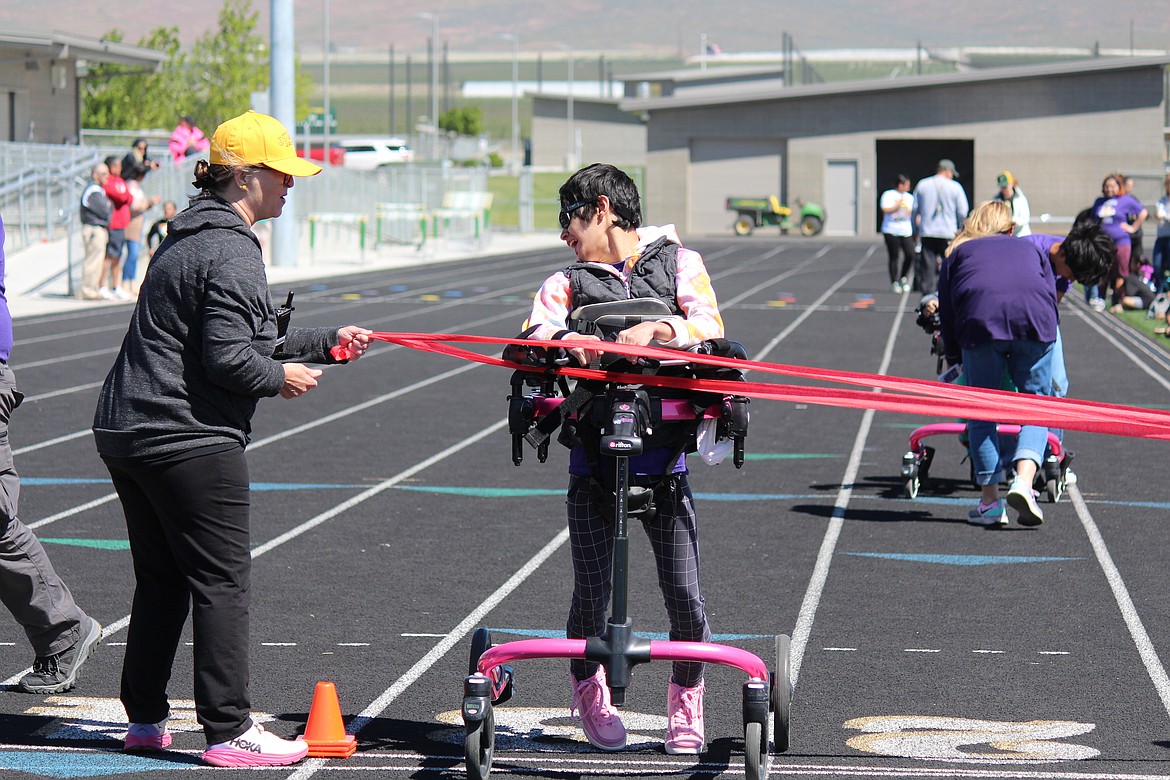 A runner in the wheelchair race crosses the finish line.