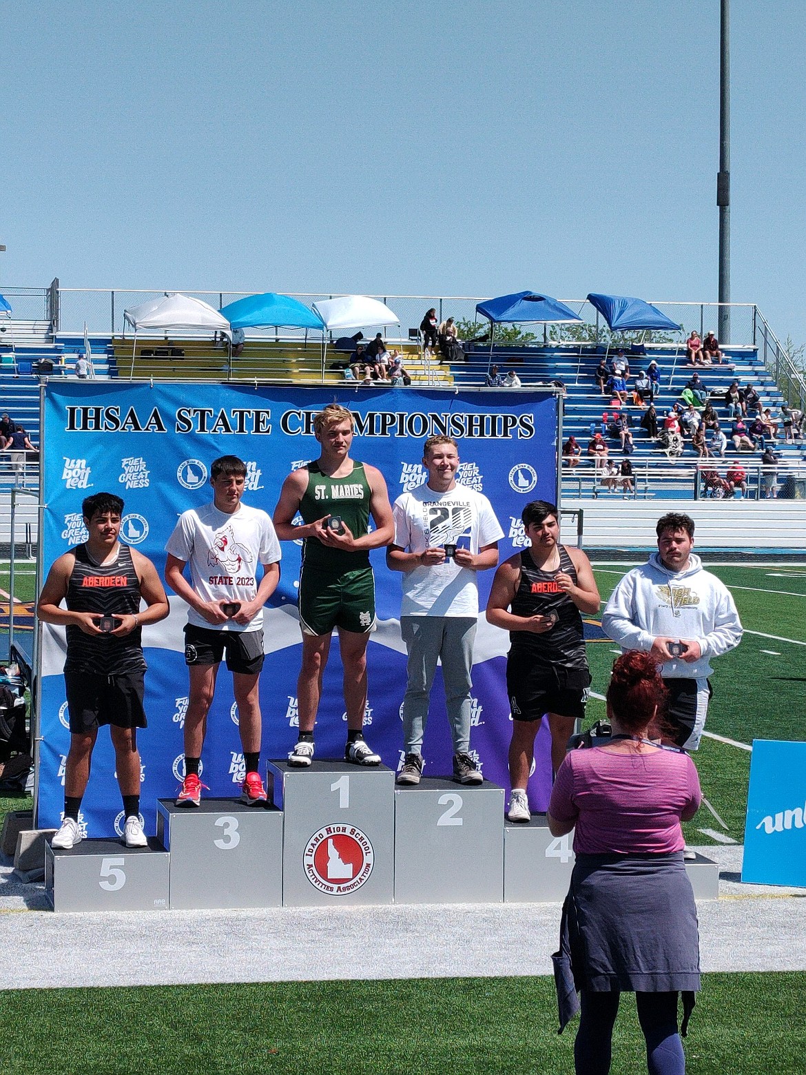 Courtesy photo
St. Maries senior Alexzander Lambson, center, receives his medal after winning the state 2A boys discus title on Friday at Middleton High School.