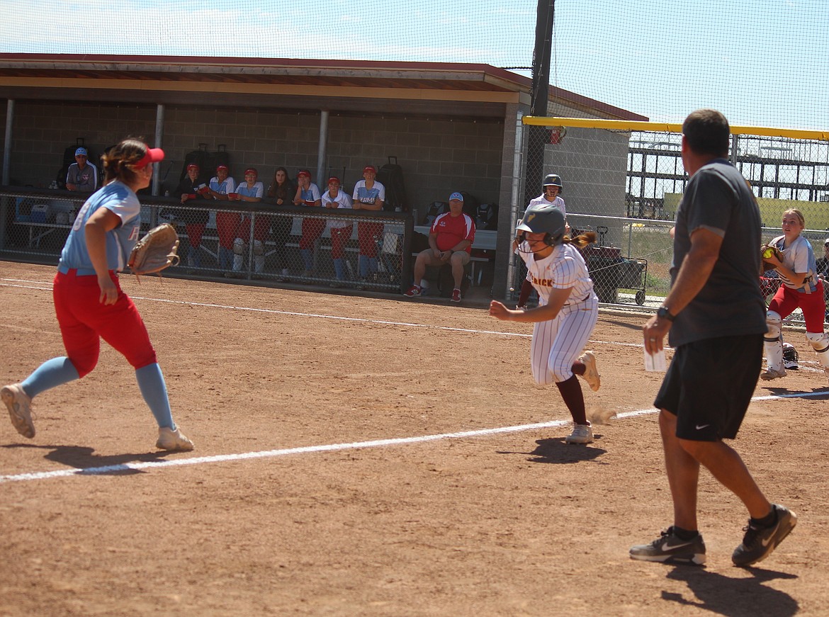 An ambiguous umpiring call left Raegan Hofheins, center, in a rundown along the third base line after her hit put Moses Lake up for good in their 7-0 win over West Valley. An appeal awarded Hofheins third base and she later scored.