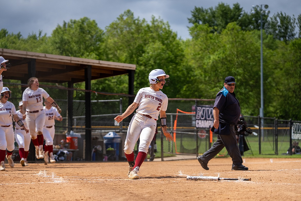 NIC ATHLETICS
North Idaho College runner Sophia Solberg celebrates as her teammates come out of the dugout to greet Tayler Thomas after Thomas' grand slam in the bottom of the fourth inning of a loser-out game in the Northwest Athletic Conference Championships on Saturday in Portland.