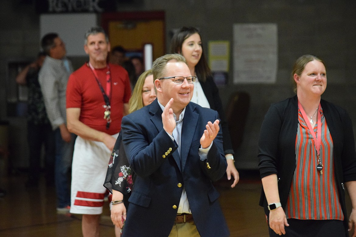 Superintendent of Public Instruction Chris Reykdal claps along with teachers and students in the middle of the Wahluke Junior High gym during an assembly Thursday afternoon.