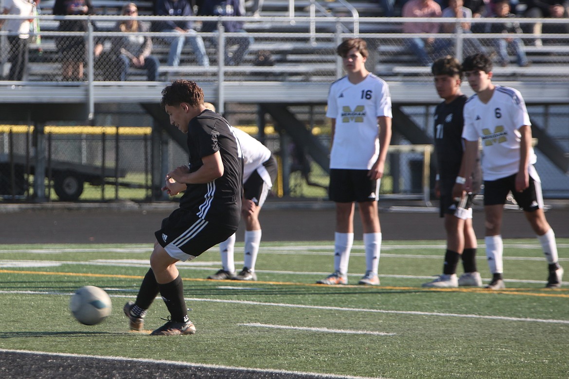 Royal senior Santiago Gonzalez, foreground, attempts a penalty kick in the 49th minute against Meridian on Friday. Gonzalez scored the game’s lone goal on the play, giving the Knights a 1-0 win.