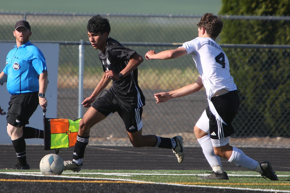 Royal senior Joby Villalobos, in black, gets past a Meridian defender during the first half against the Trojans.