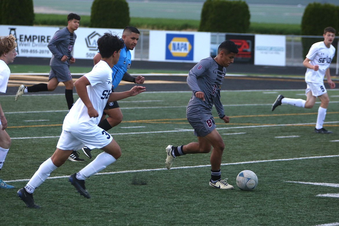 Wahluke senior Brian Herrera (8) runs through the Seton Catholic defense during the first half of Friday’s state playoff match against the Cougars.