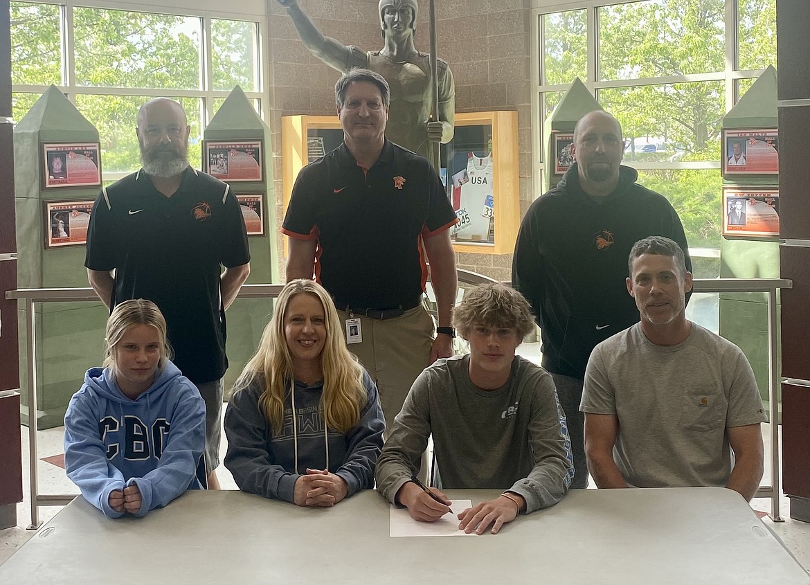 Courtesy photo
Post Falls High senior Neil McCarthy recently signed a letter of intent to play basketball at Columbia Basin College in Pasco, Wash. Seated from left are Kalin McCarthy, Lacy McCarthy, Neil McCarthy and Rob McCarthy; and standing from left, Mike McLean, Post Falls High head boys basketball coach; Craig Christensen, Post Falls High athletic director; and Brian Carlson, Post Falls High assistant boys basketball coach.