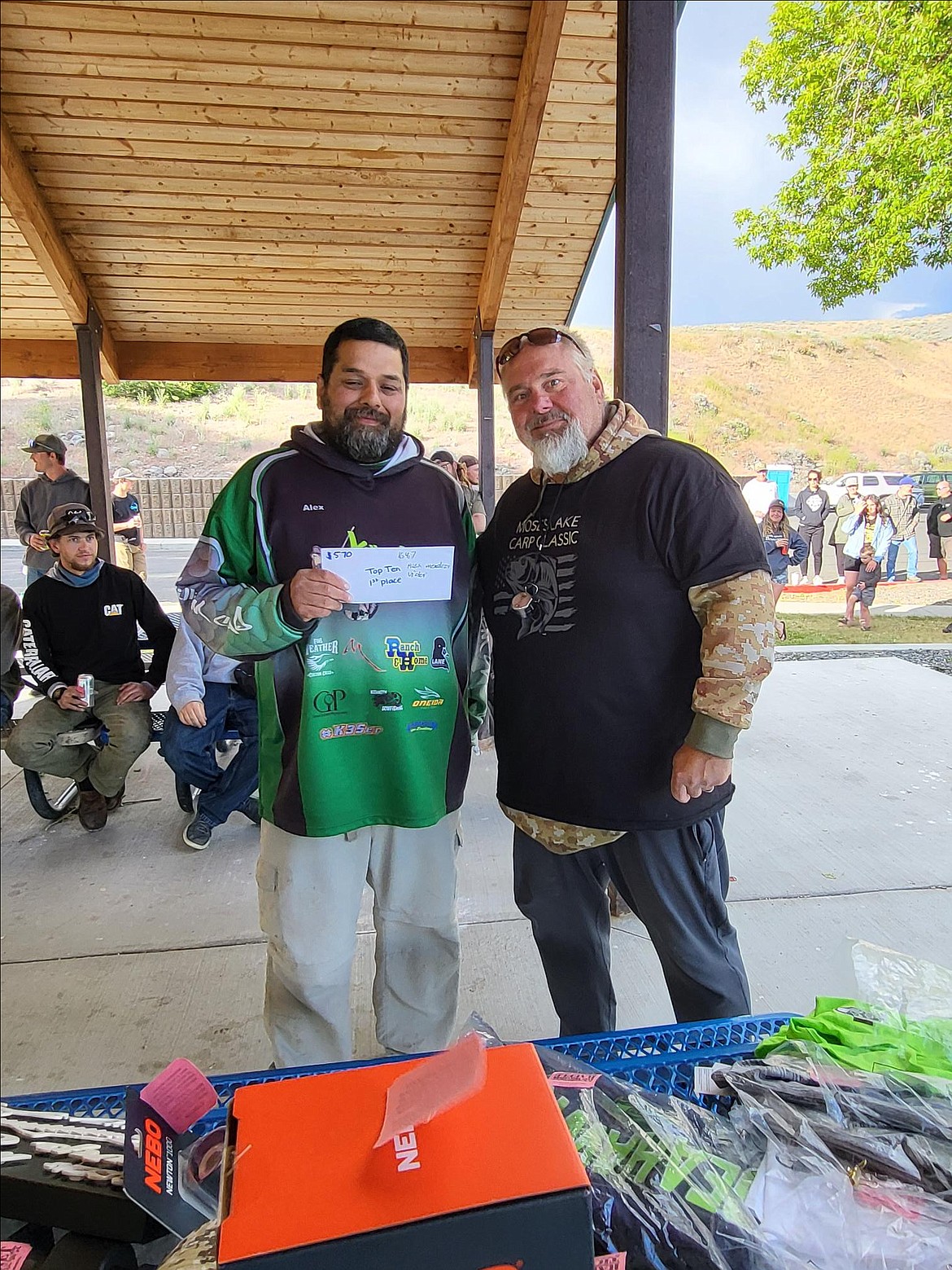 Alex Mendoza, left, accepts the prize for the 10 biggest fish by weight at the 2024 Carp Classic. He teamed up with Victor Mendoza to take first.