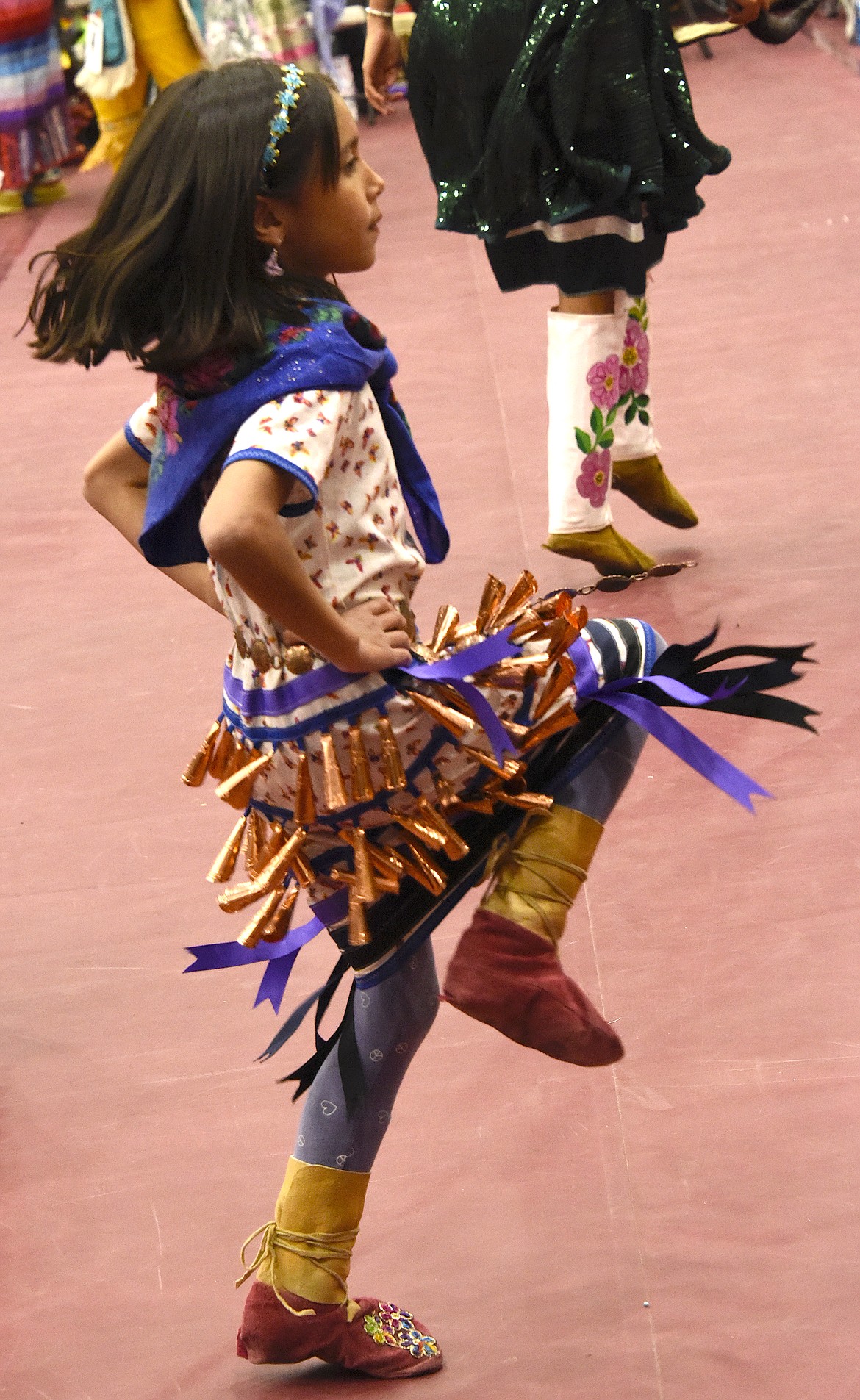 A young jingle dancer has every jingle on her outfit tinkling. (Berl Tiskus/Leader)