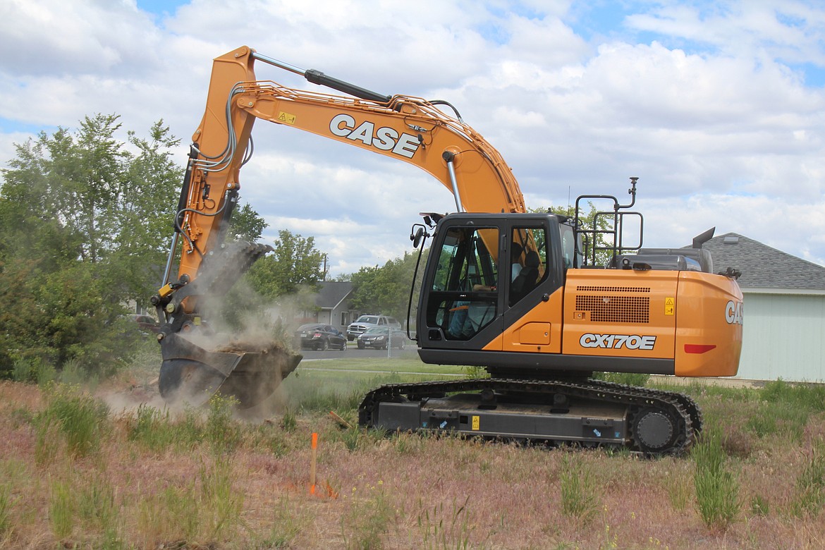 Dirt starts to fly on the site of the new Habitat for Humanity house in Moses Lake.