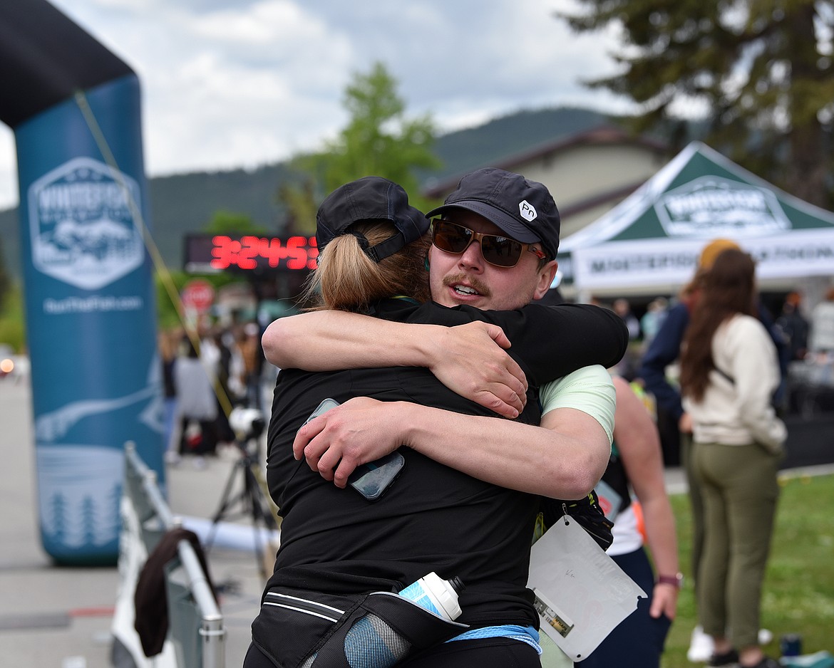 Post-run congratulatory hugs abounded at the finish line of the Whitefish Marathon. (Julie Engler/Whitefish Pilot)