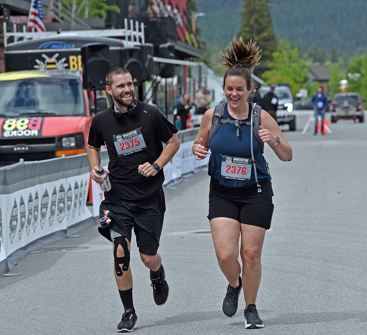 Runners of the half marathon cross the finish line Saturday. (Julie Engler)