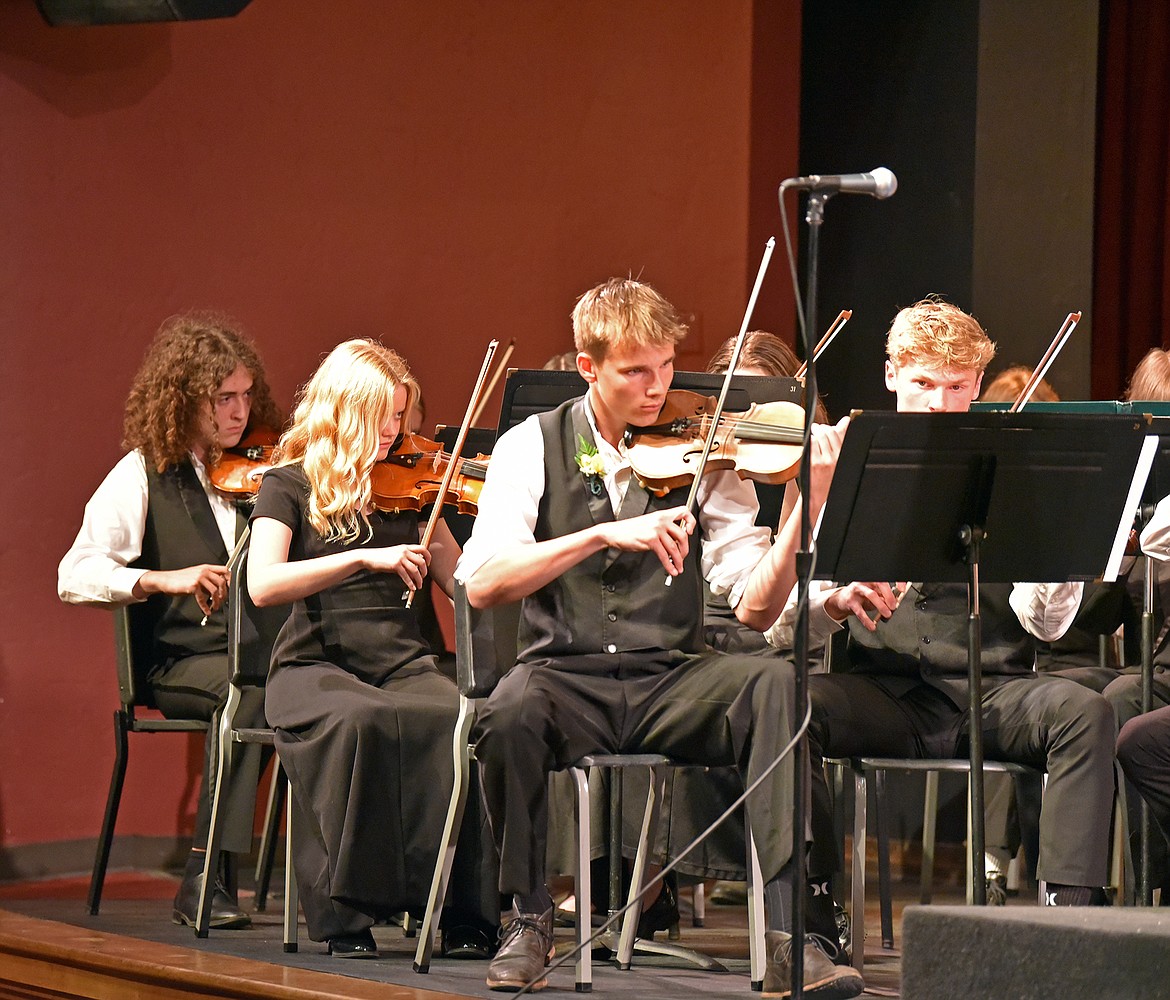 Violinists Jackson Schindler, Isabelle Cosby, Carson Krack and Jackson Dorvall play at the Whitefish High School's Spring Orchestra Concert May 14, 2024. (Julie Engler/Whitefish Pilot)