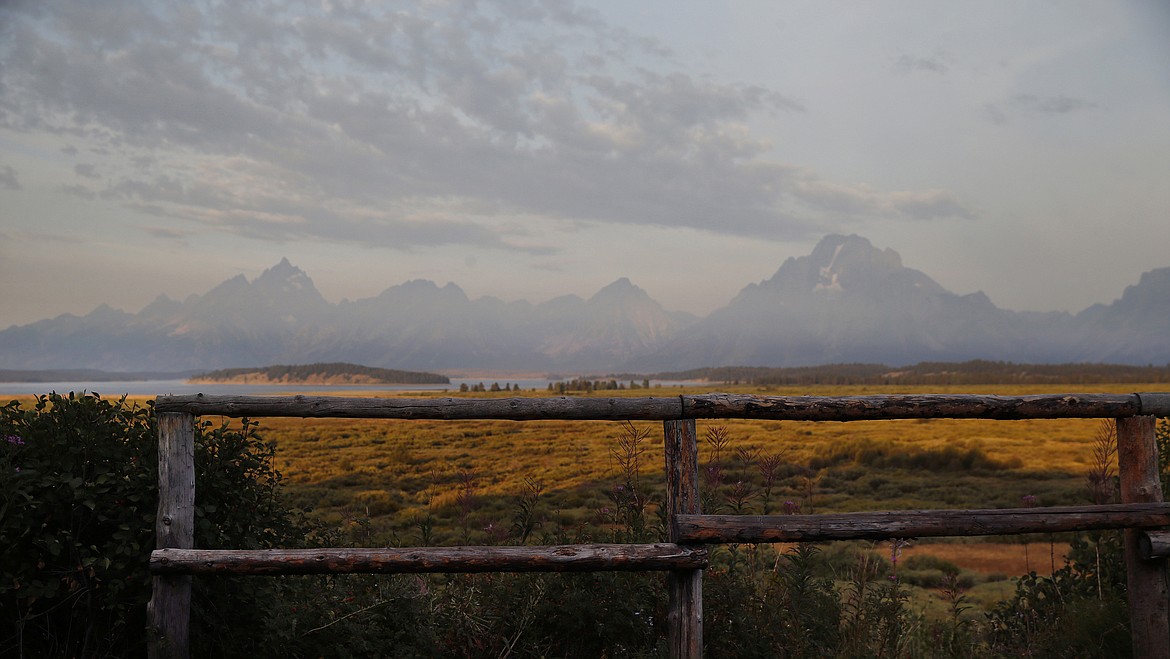 The morning sun illuminates the Grand Tetons, Aug. 26, 2016, in Grand Teton National Park, north of Jackson Hole, Wyo. A grizzly bear attacked and seriously injured a man in western Wyoming's Grand Teton National Park, prompting closure of a mountain there Monday, May 20, 2024. (AP Photo/Brennan Linsley, File)