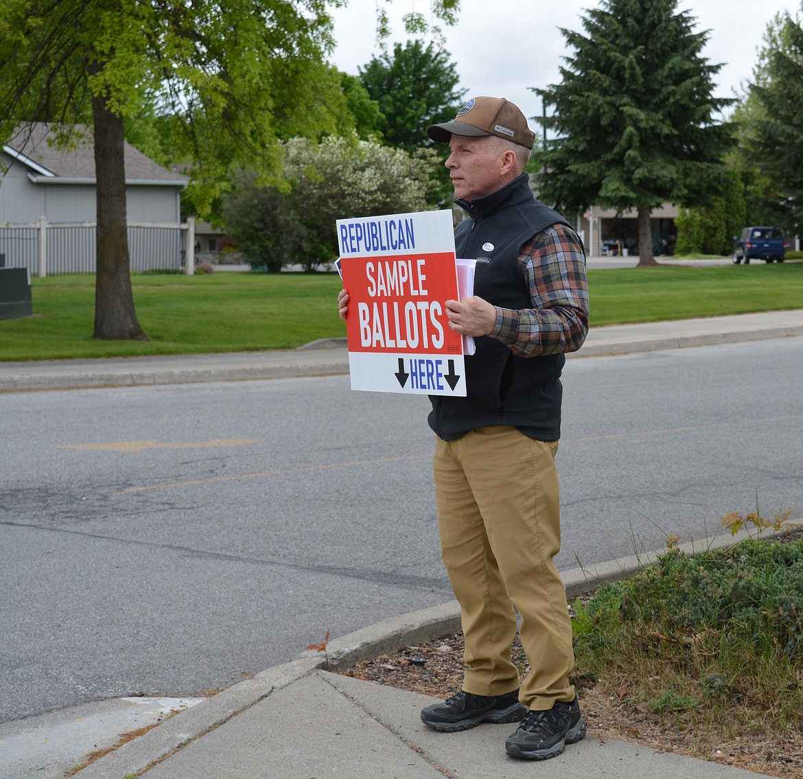 Mike Burns, of Coeur d'Alene, arrived around 4 p.m. to N. Ramsey Road to distribute Republican sample ballots to voters outside Lake City High School for the primary election. "I’m here until the polls close," Burns said.