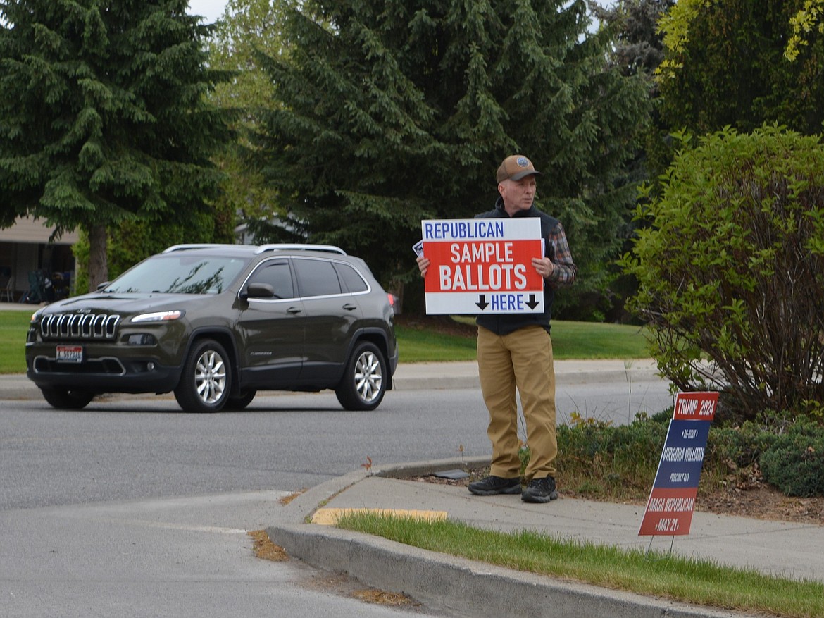 "I’m here until the polls close," Mike Burns, of Coeur d'Alene, said. He arrived around 4 p.m. Monday on N. Ramsey Road to distribute Republican sample ballots with primary election voters.