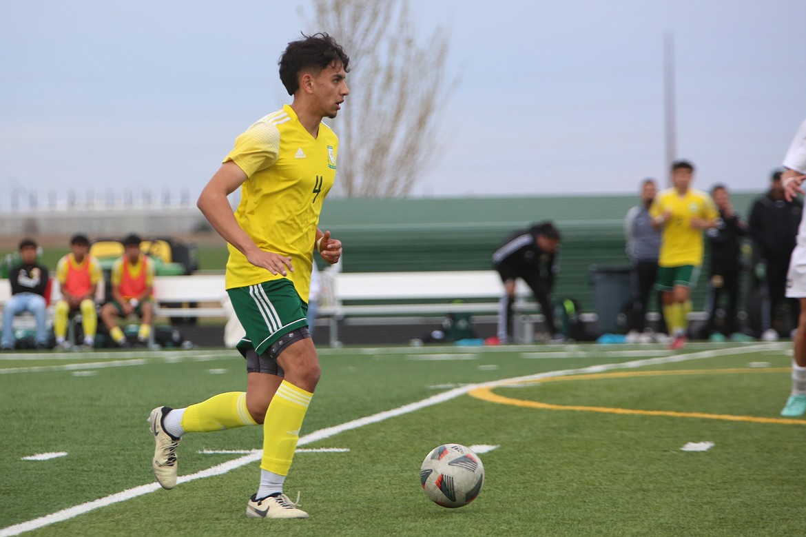 Quincy senior Guillermo Gomez brings the ball up the field during an April 11 match against Chelan. Gomez is one of six Jackrabbit seniors graduating off of this year’s roster.