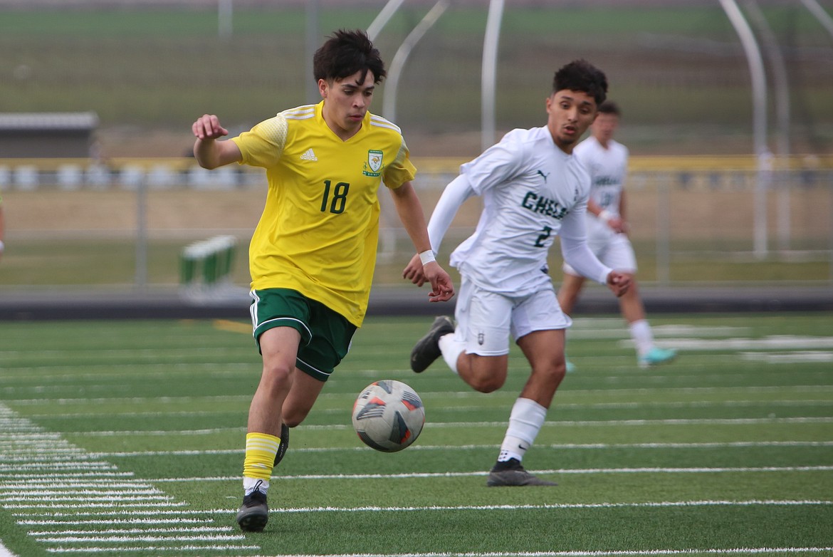 Quincy sophomore Gerardo Silvas (18) rushes past a Chelan defender during an April 11 match. Head Coach Hector Vaca said the Jacks have 13 sophomores that will return next season.