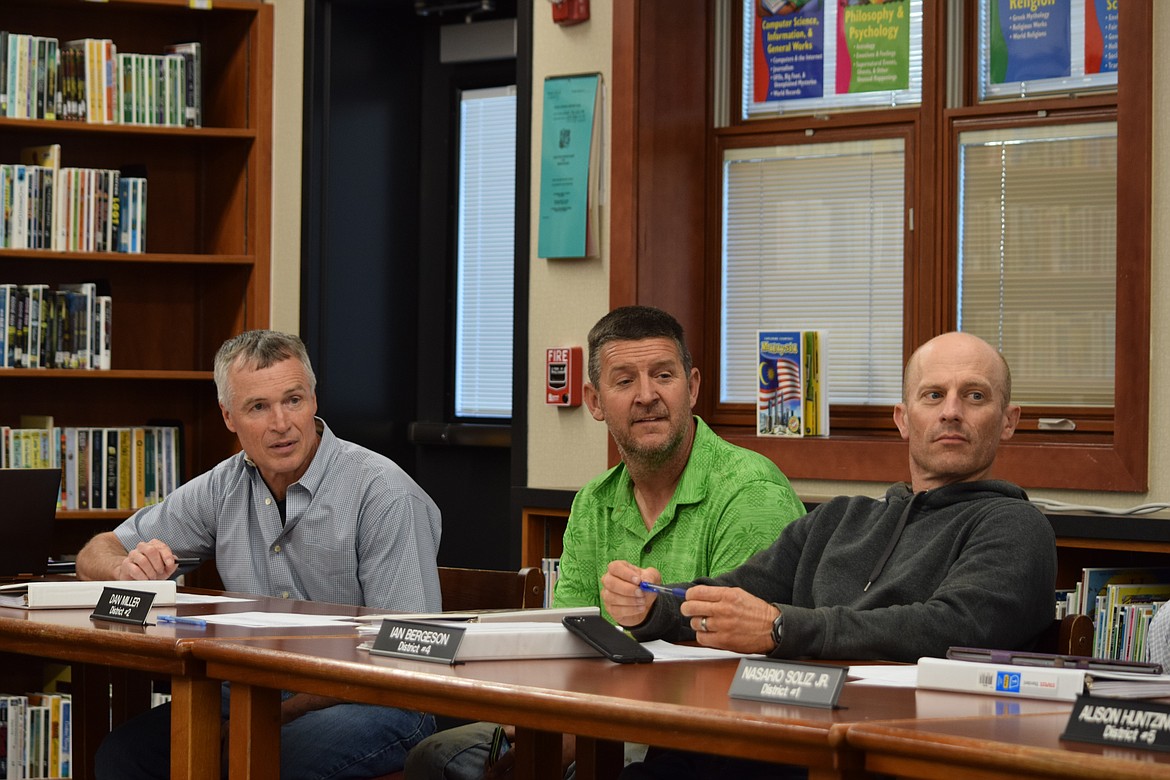 Royal School Board members, from left to right, Craig Janett, Dan Miller and Ian Bergeson discuss the possible purchase of new vans for increased transportation capacity.
