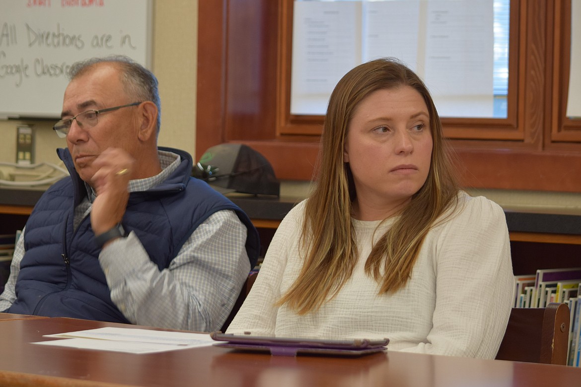 Royal School Board members Nasario Soliz, left, and Alison Huntzinger, right, listen to staff during Monday’s meeting.