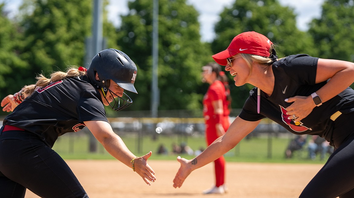 NIC ATHLETICS
North Idaho College softball coach Shay Chapman, right, congratulates Hayden Rockwell after her home run against Lower Columbia last Friday at the Northwest Athletic Conference Championships in Portland.